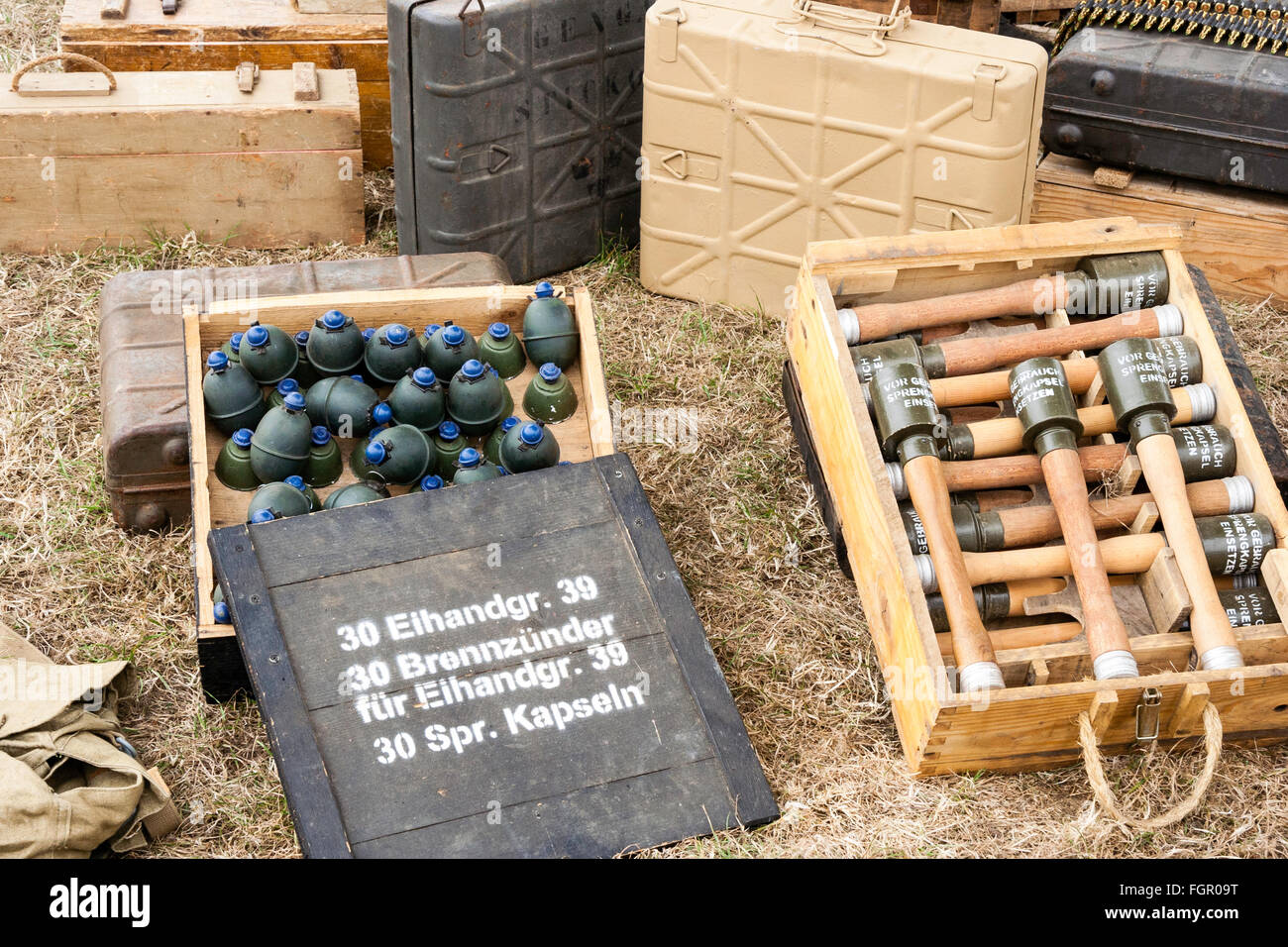 Second World War re-enactment. Box of German stielhandgranate, stick grenades and crate of M39 Egg-Shaped Grenades with blue fuse tops. Stock Photo