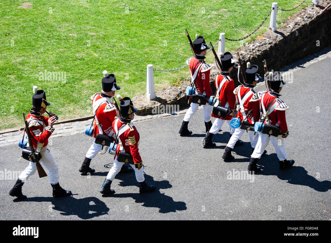 High angle viewpoint looking down on patrol of 19th century Redcoats of 1st regiment of Foot Guards, Marching away. Re-enactment at Dover castle. Stock Photo