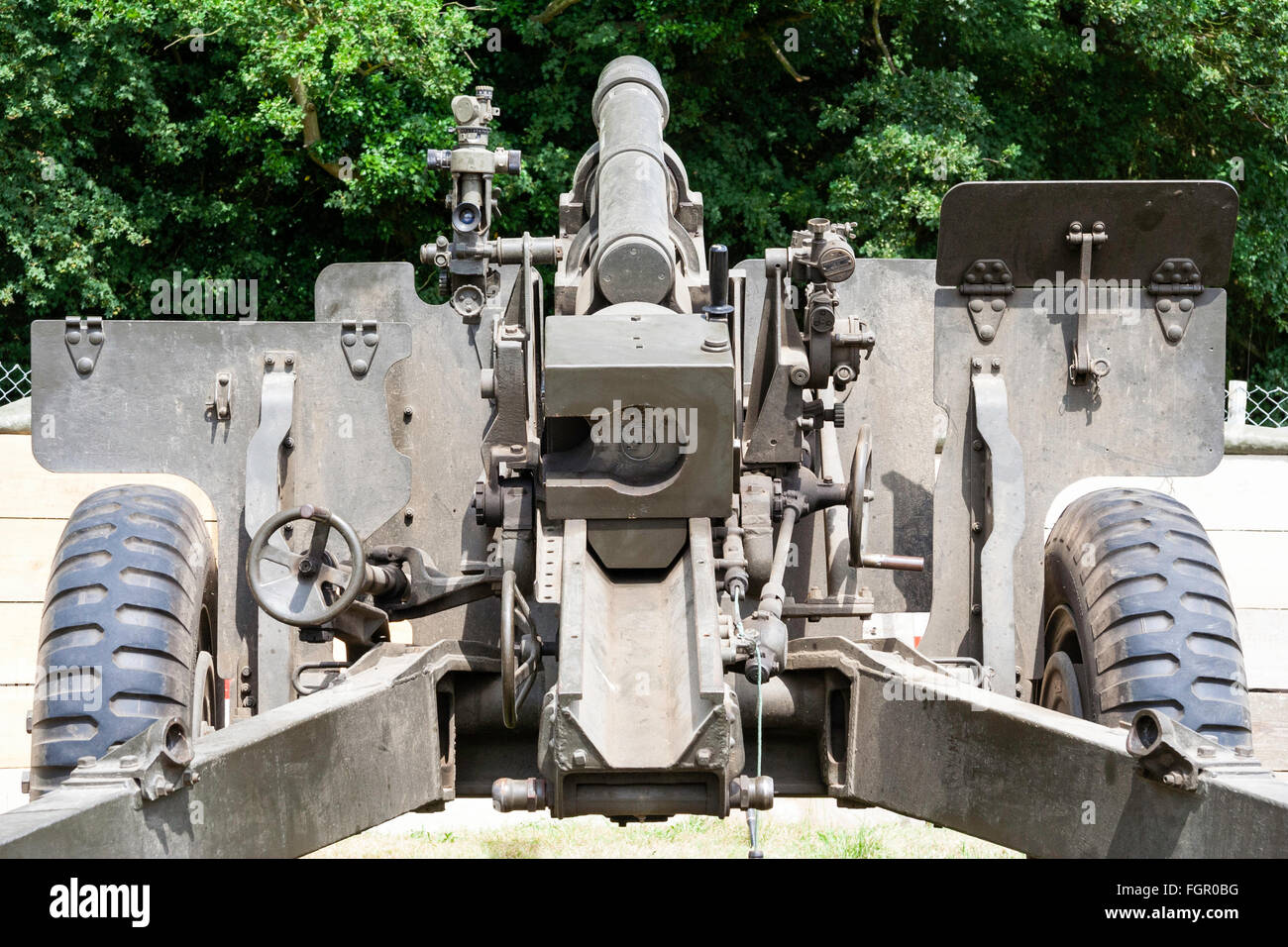 Vietnam war re-enactment. Rear view of American 105mm howitzer artillery gun, set up in fire support base. Close up. Stock Photo