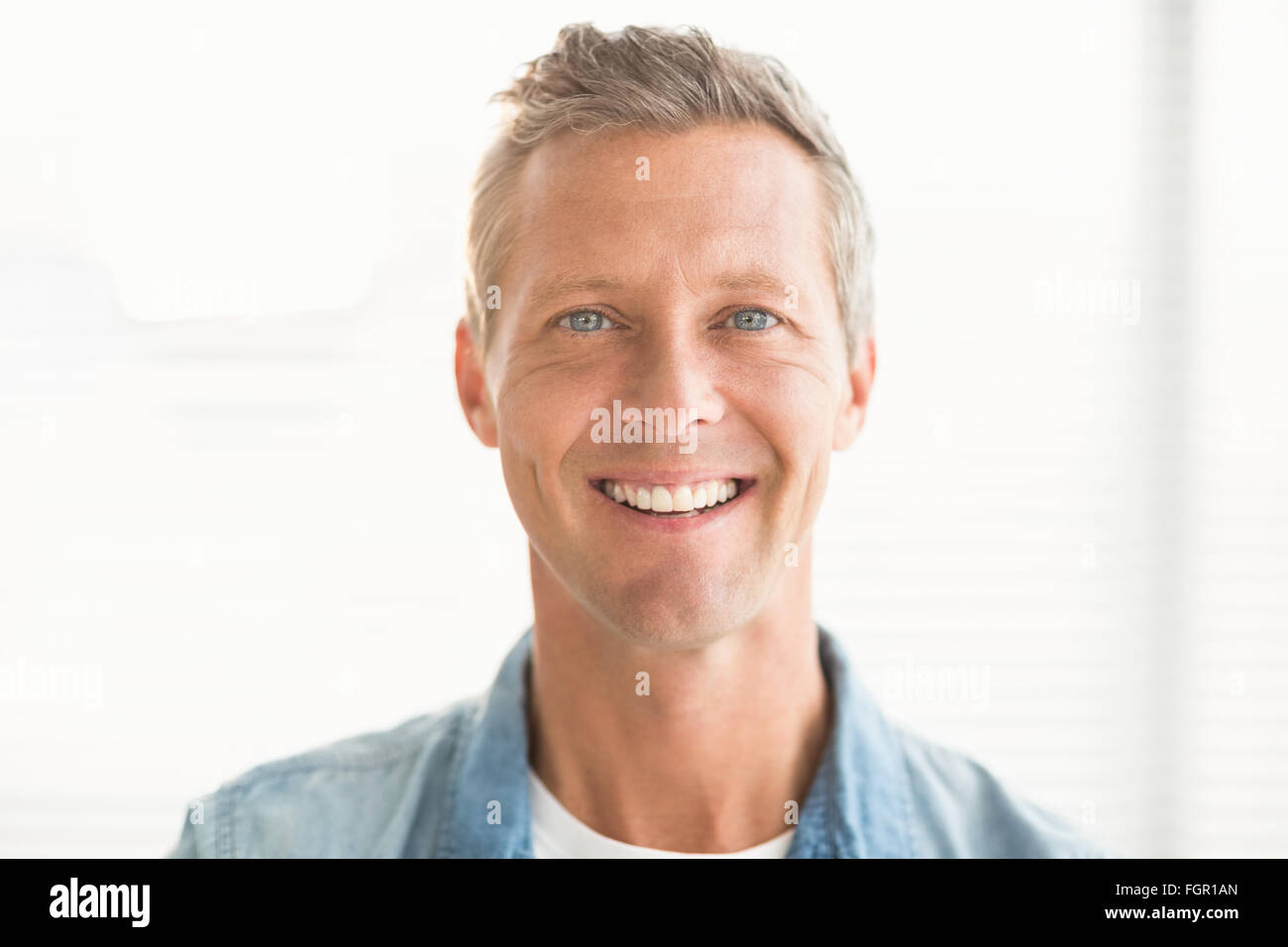 Smiling businessman looking at the camera Stock Photo - Alamy
