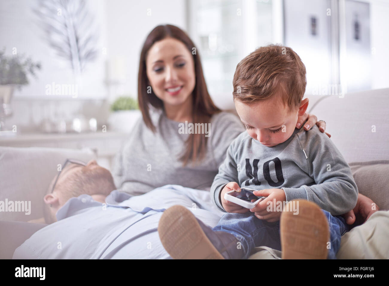 Curious toddler using cell phone Stock Photo