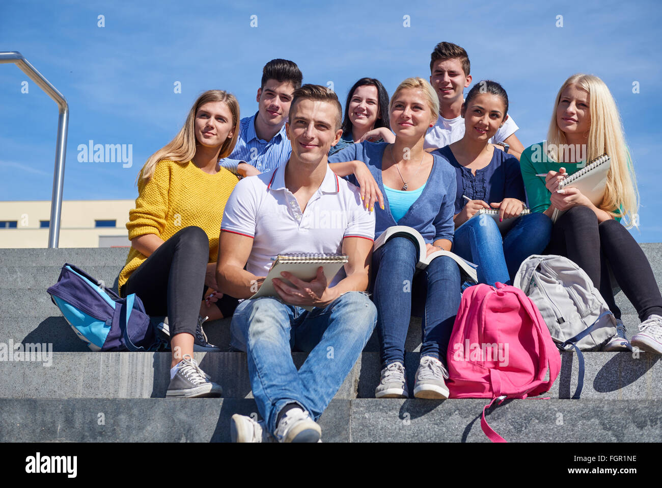 students outside sitting on steps Stock Photo