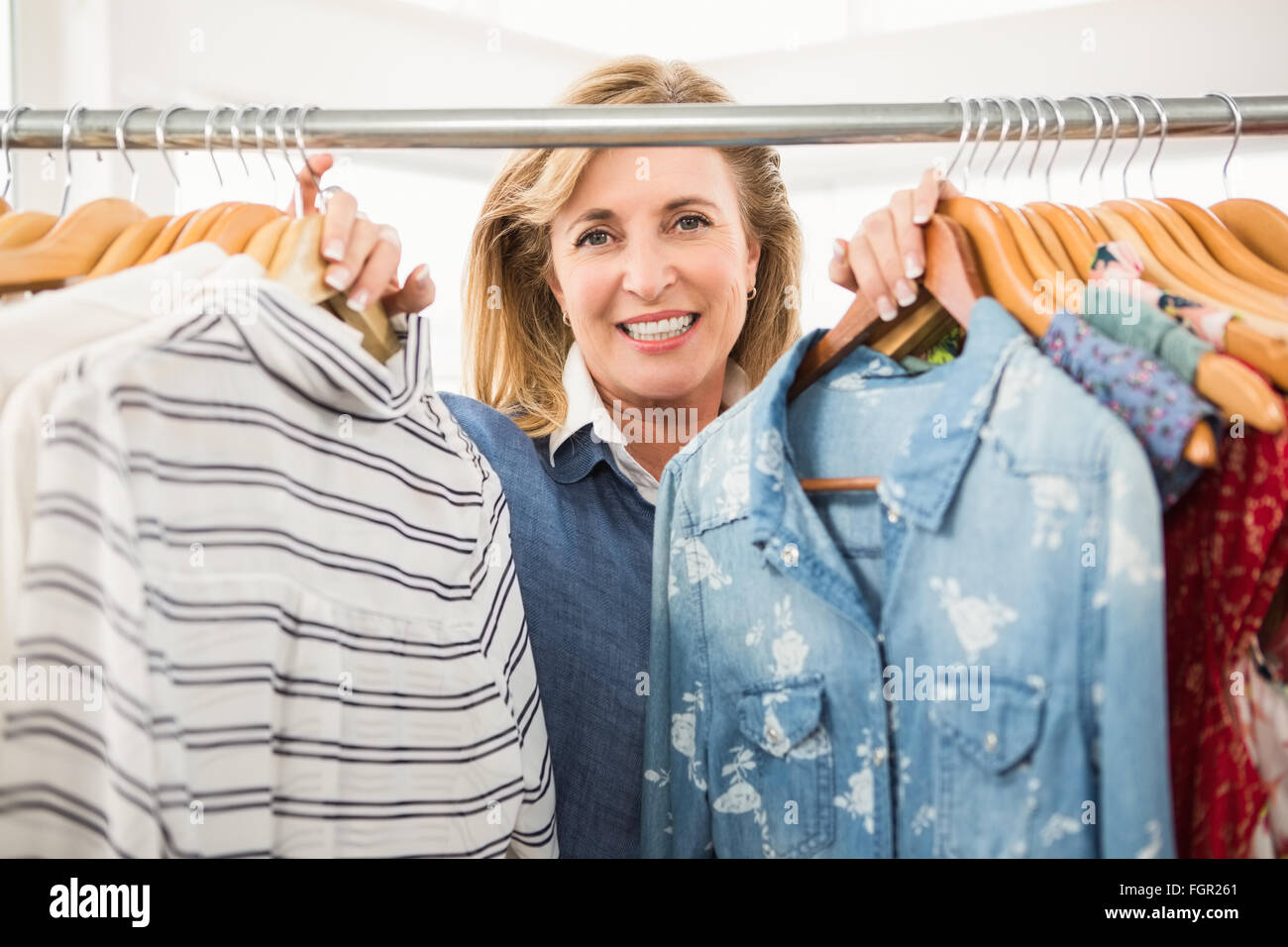 Woman looking through clothes rail hi res stock photography and images Alamy