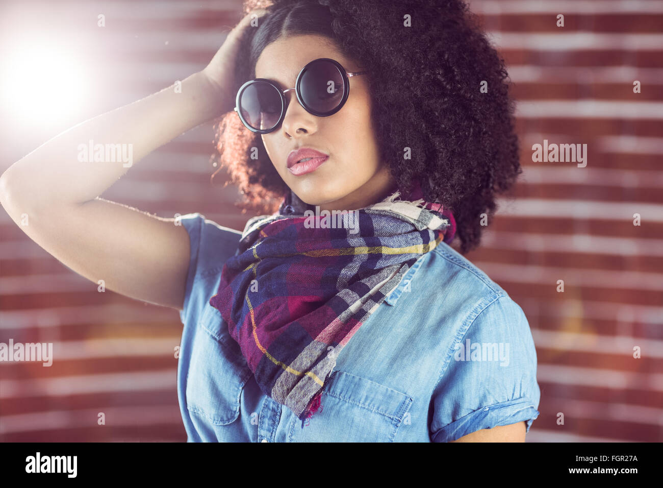 Attractive young woman wearing sunglasses Stock Photo - Alamy