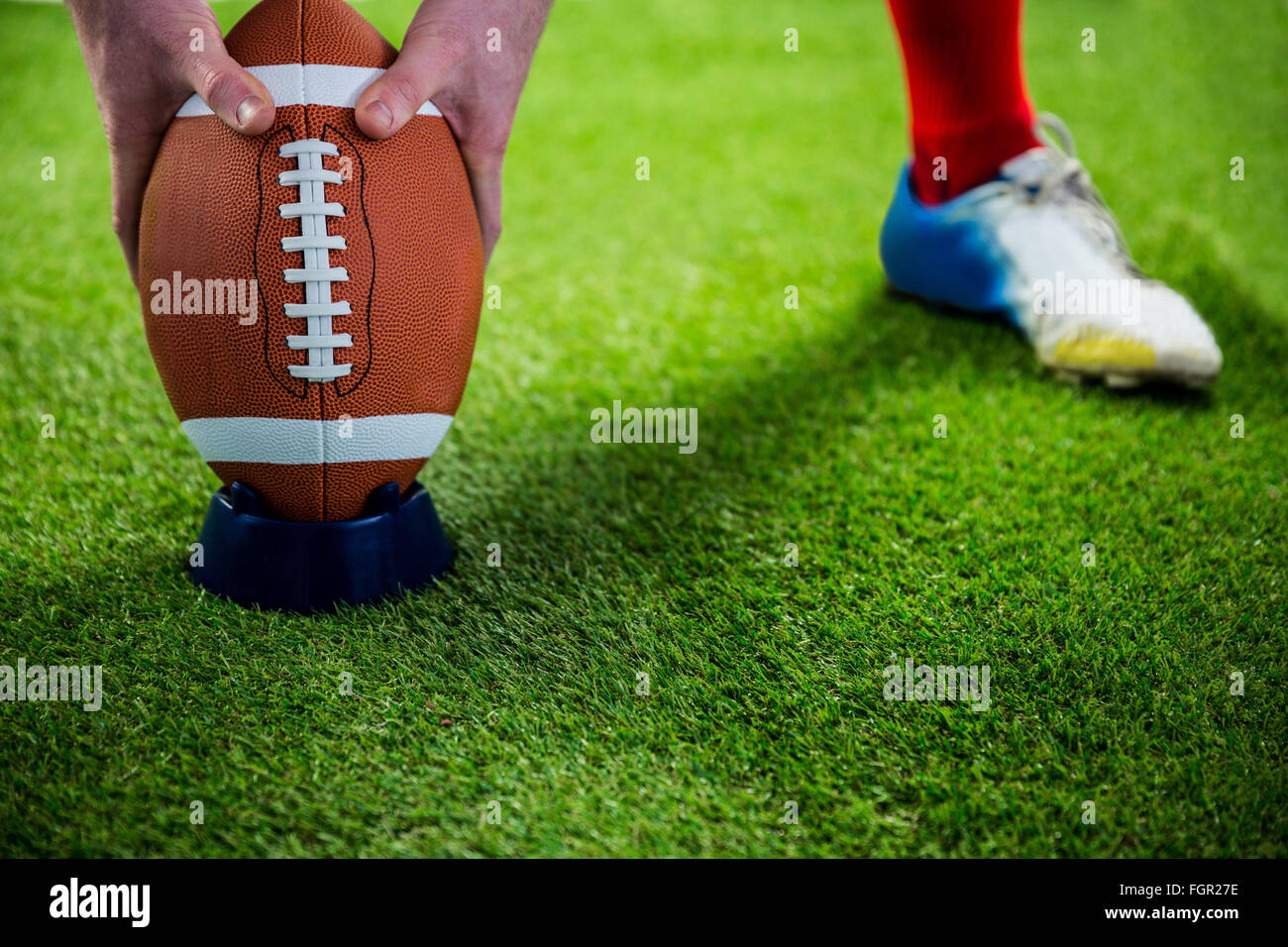 American football player preparing for a drop kick Stock Photo Alamy