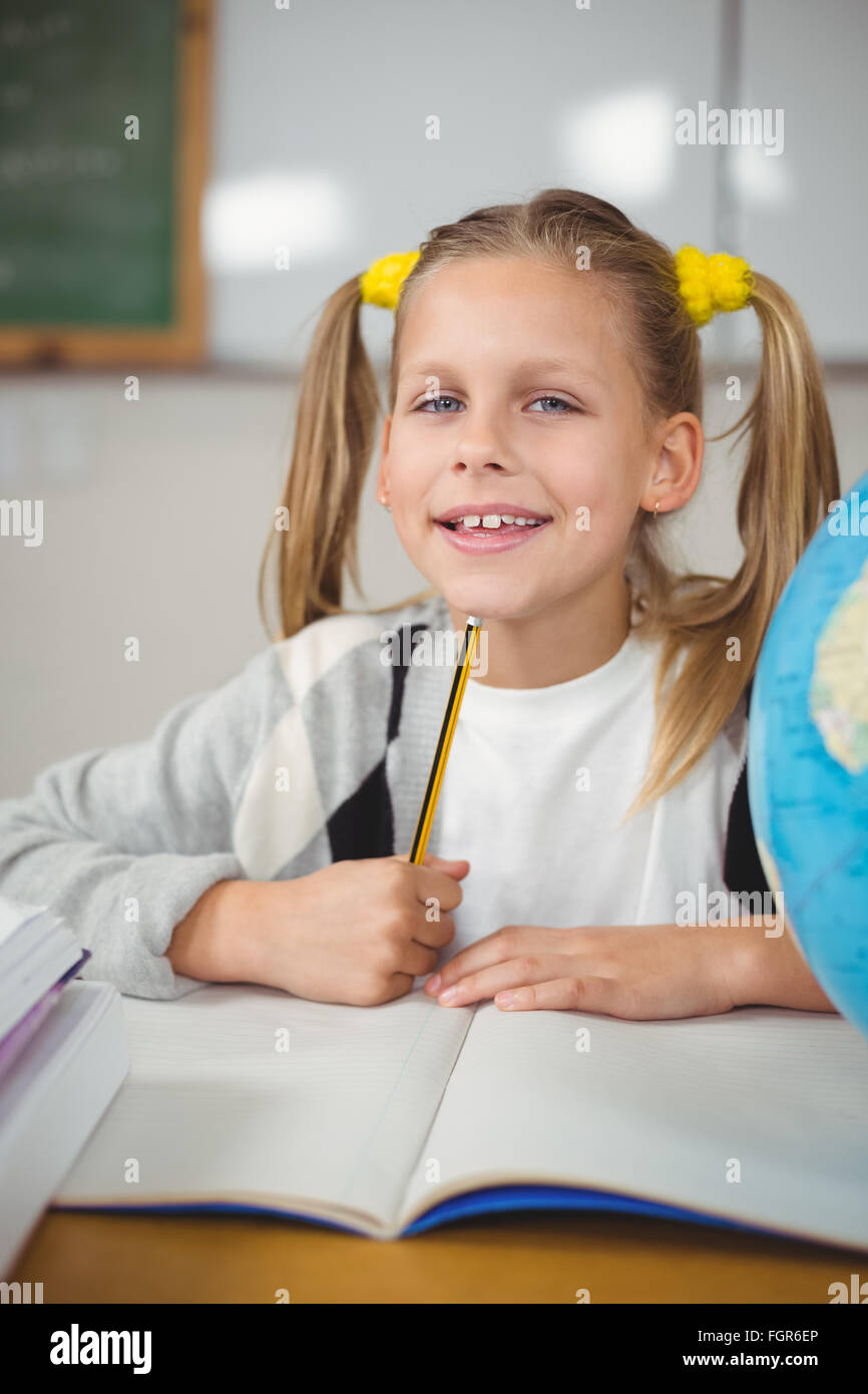 Cute pupil sitting at her desk in a classroom Stock Photo - Alamy