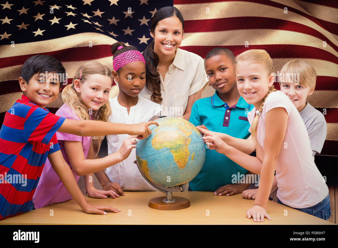 Composite image of cute pupils and teacher looking at globe in library ...