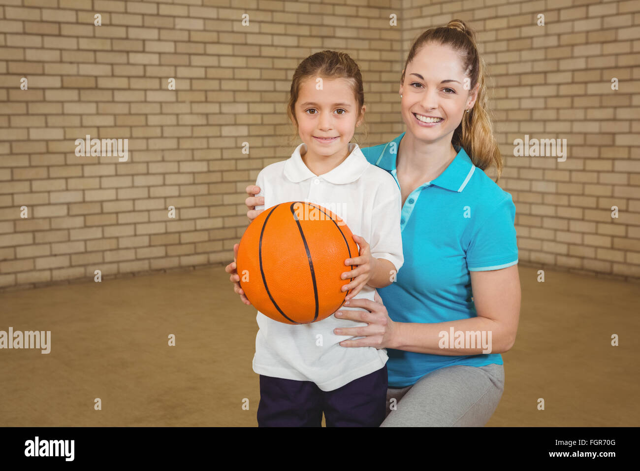 Student holding basketball with teacher Stock Photo Alamy