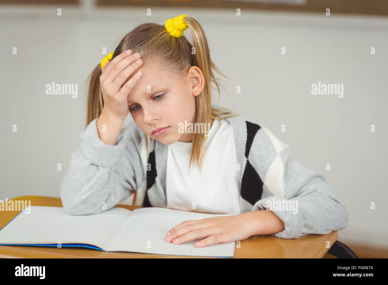 Concentrated pupil working at her desk in a classroom Stock Photo - Alamy