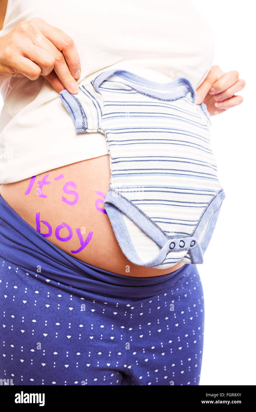 Pregnant woman holding pyjamas over her belly Stock Photo
