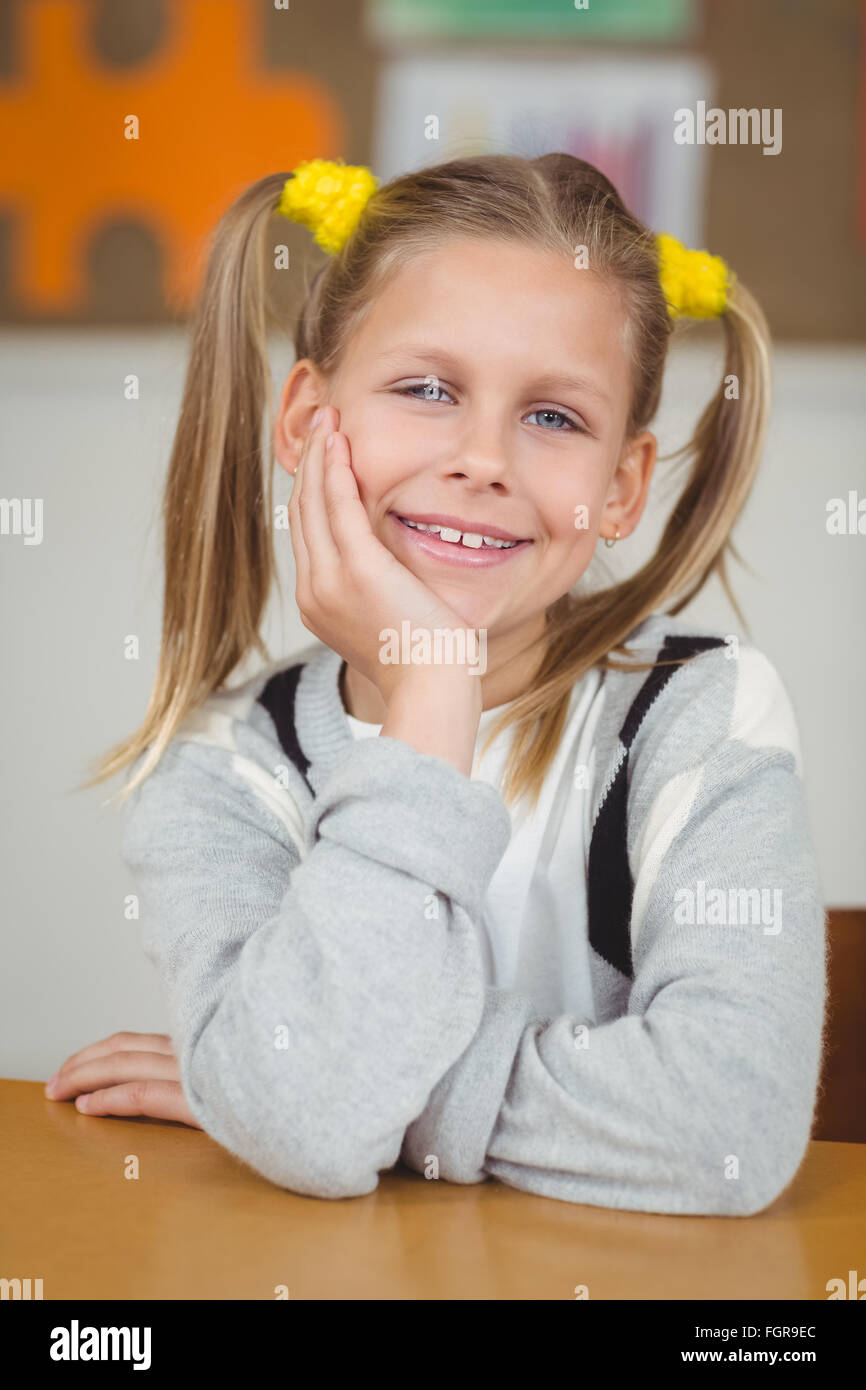 Cute pupil sitting at her desk in a classroom Stock Photo - Alamy