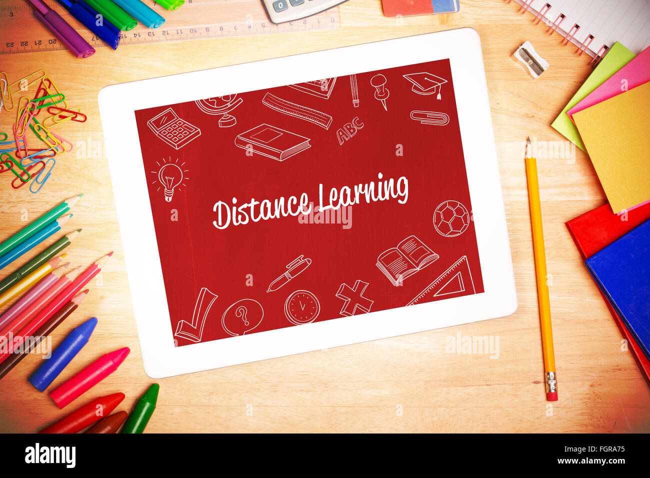 Distance learning against students desk with tablet pc Stock Photo - Alamy