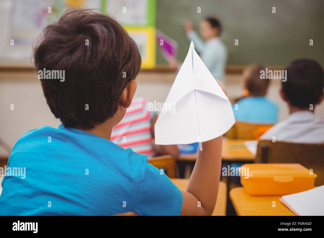 Pupil about to throw paper airplane Stock Photo Alamy