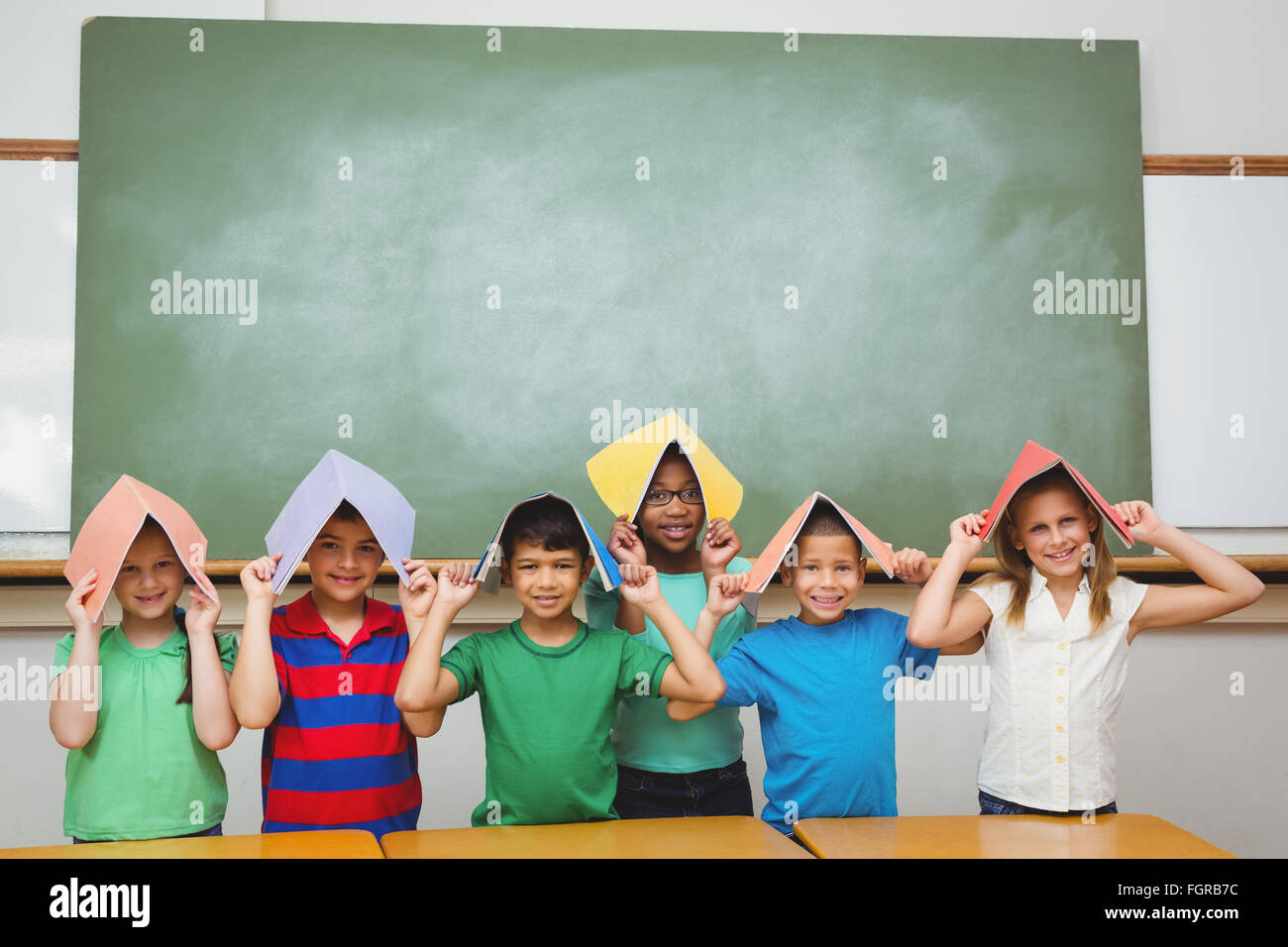 Boy holding book over head hi-res stock photography and images - Alamy
