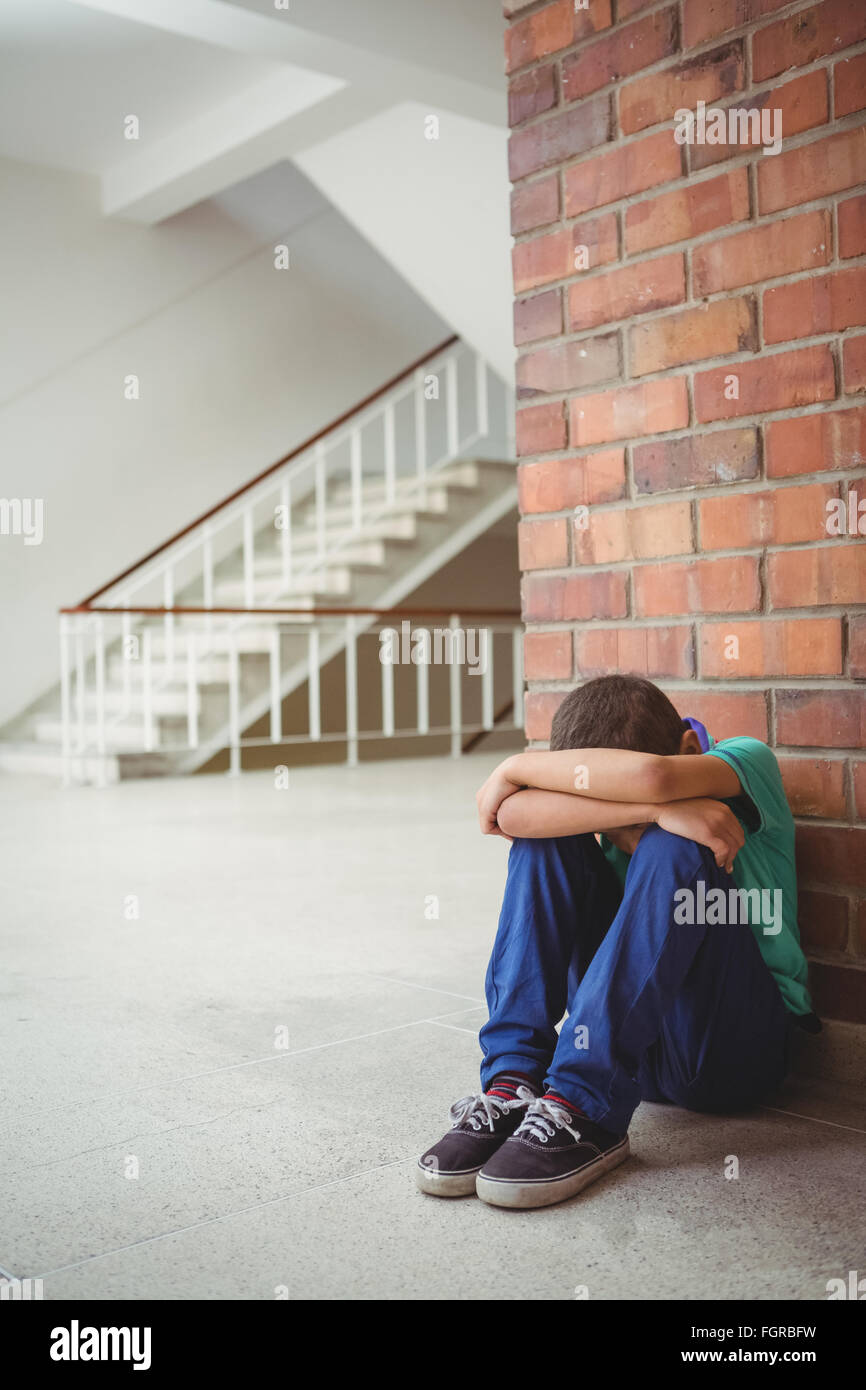 Upset lonely child sitting by himself Stock Photo