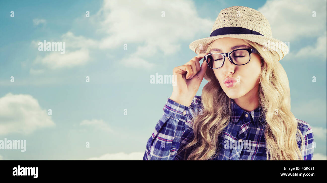 Composite image of gorgeous blonde hipster sending air kiss Stock Photo