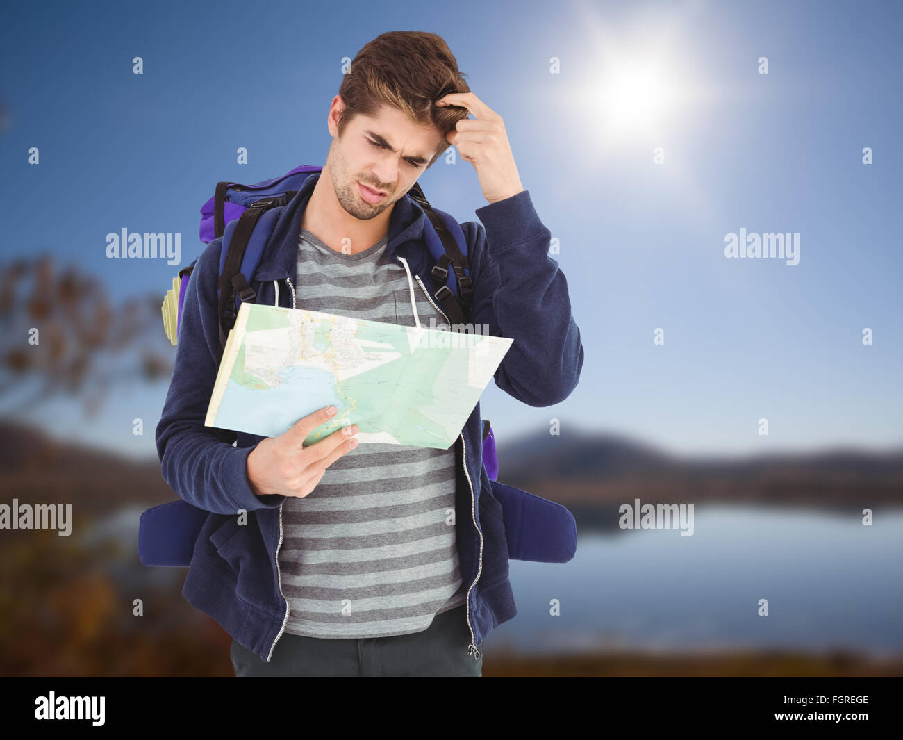 Composite image of man scratching head while looking in map Stock Photo