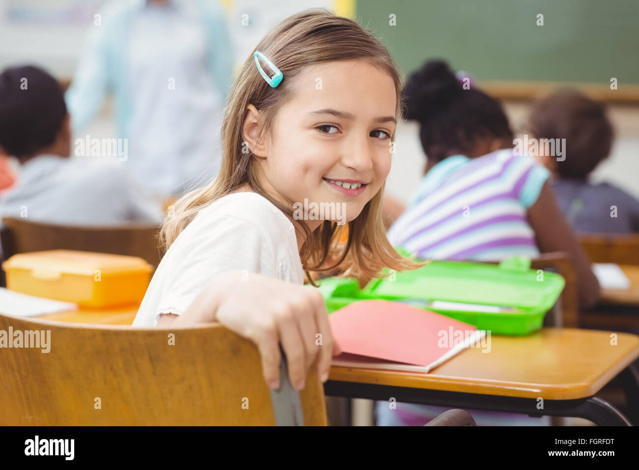 Pupil smiling at camera during class Stock Photo - Alamy