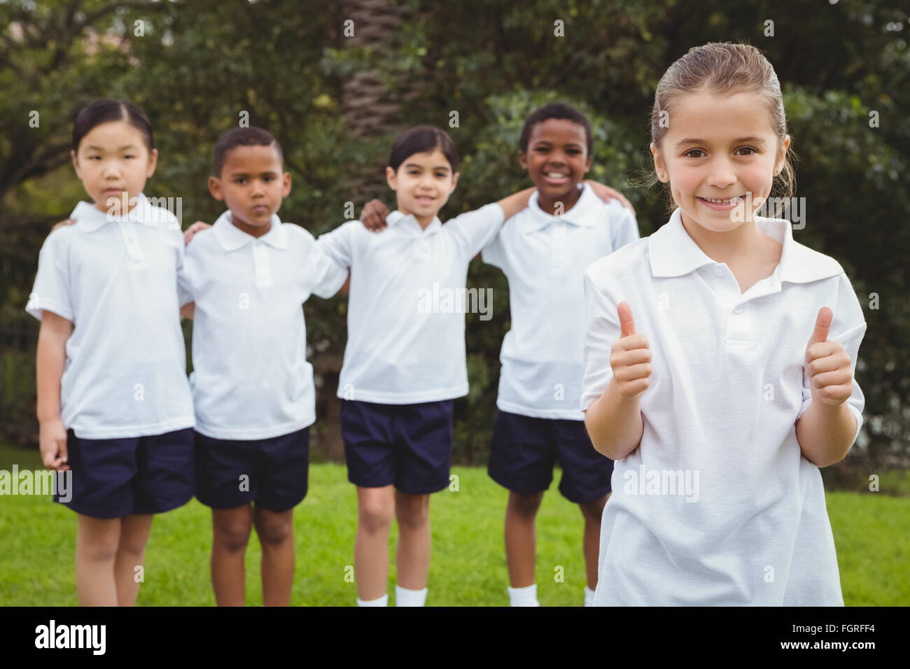 Student standing with thumbs up Stock Photo - Alamy