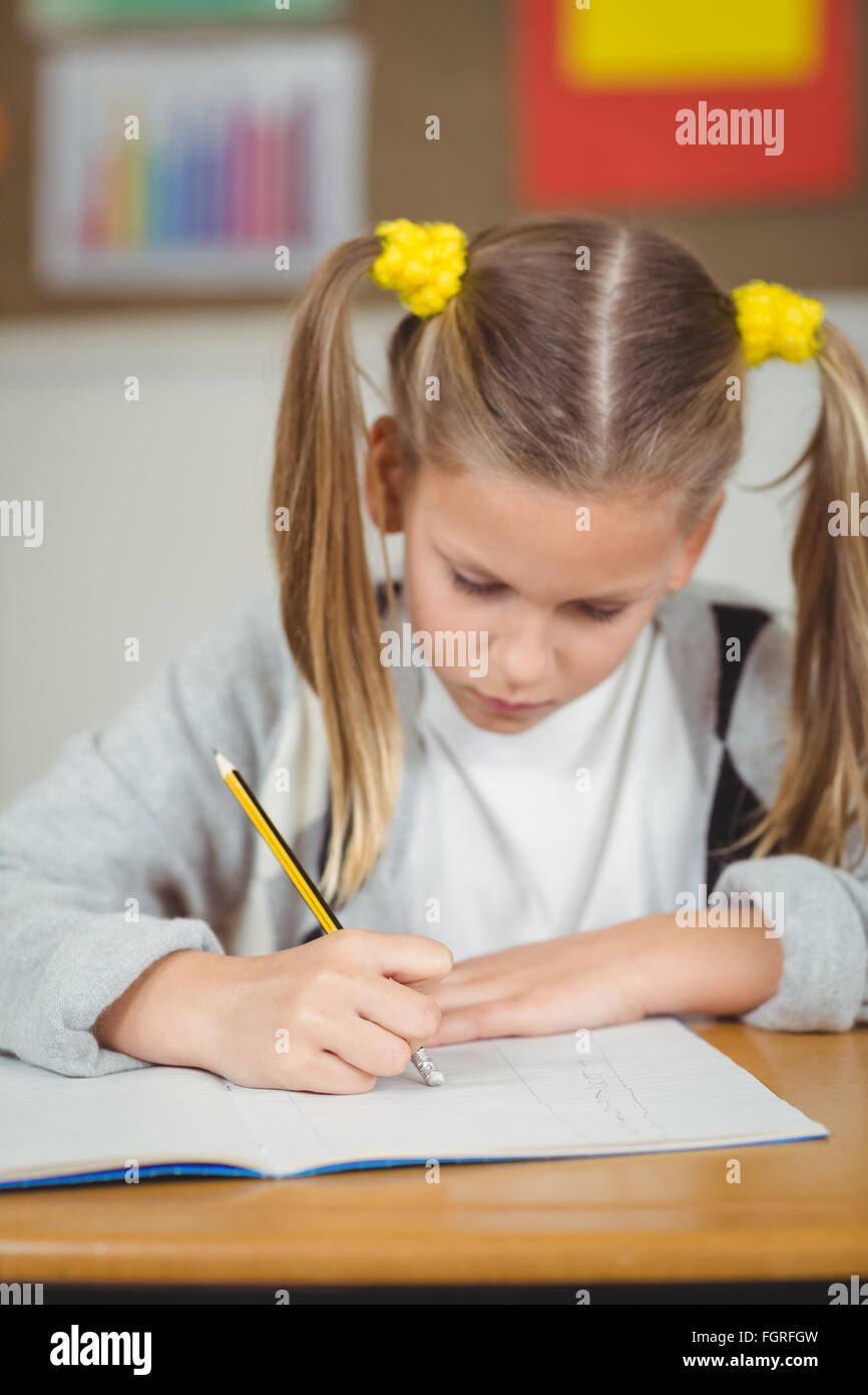 Concentrated pupil working at her desk in a classroom Stock Photo - Alamy