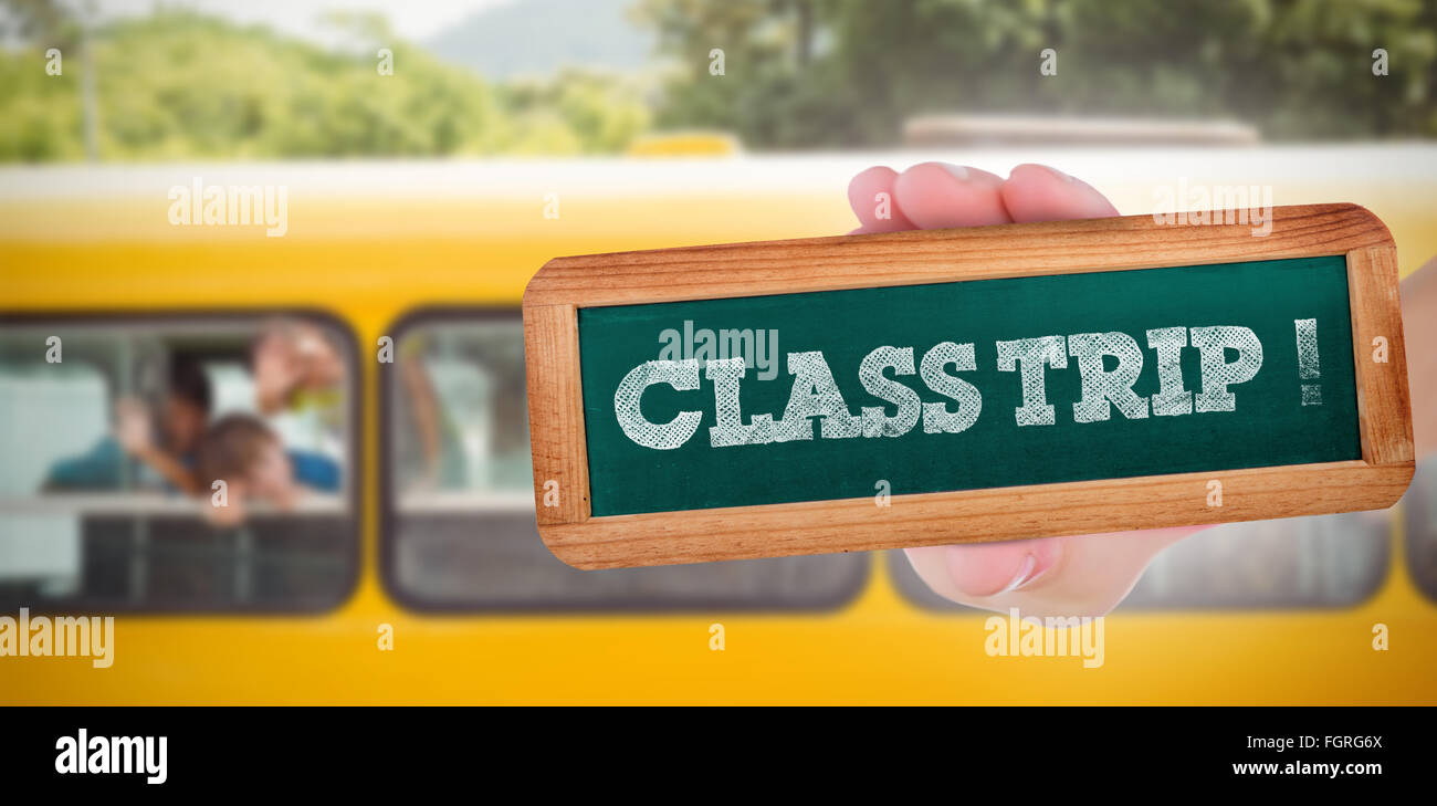 Class trip! against cute pupils smiling at camera in the school bus Stock Photo