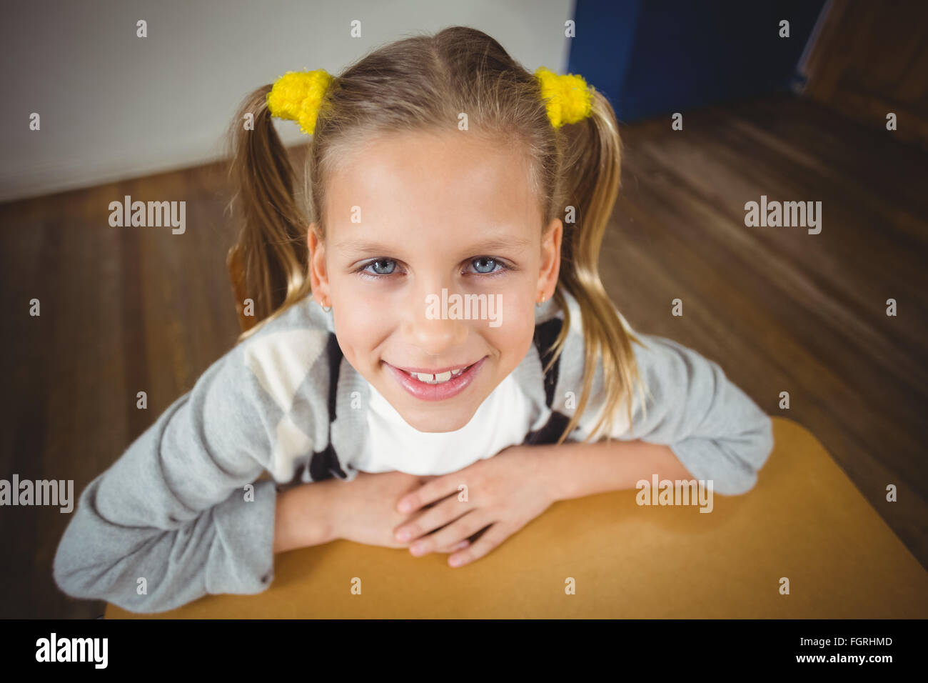 Cute pupil sitting at her desk in a classroom Stock Photo - Alamy