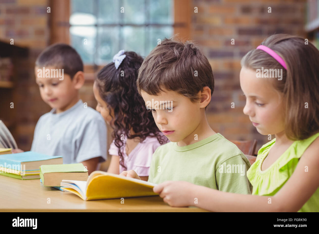 Pupils reading books in library Stock Photo - Alamy