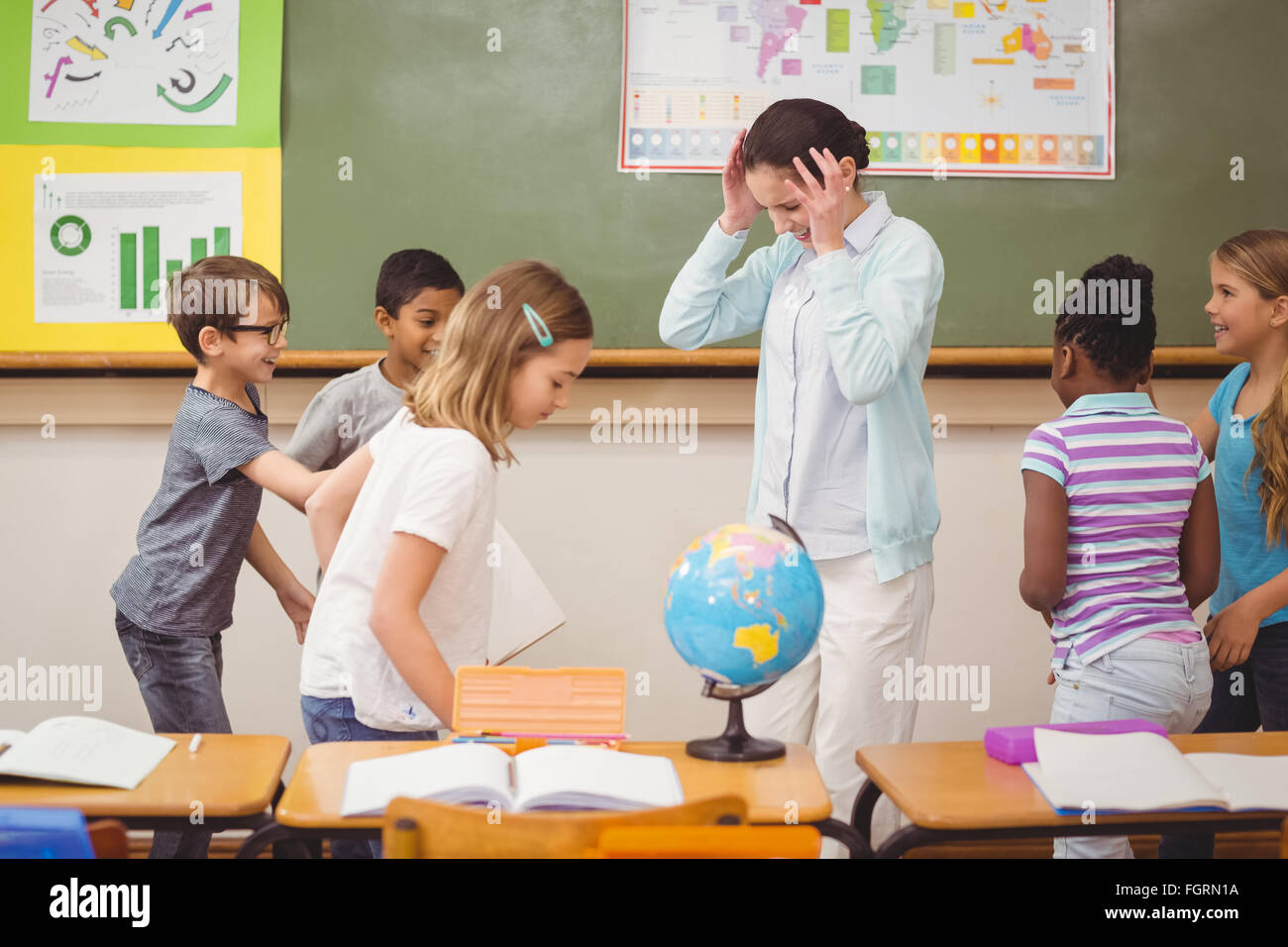 Pupils running wild in classroom Stock Photo