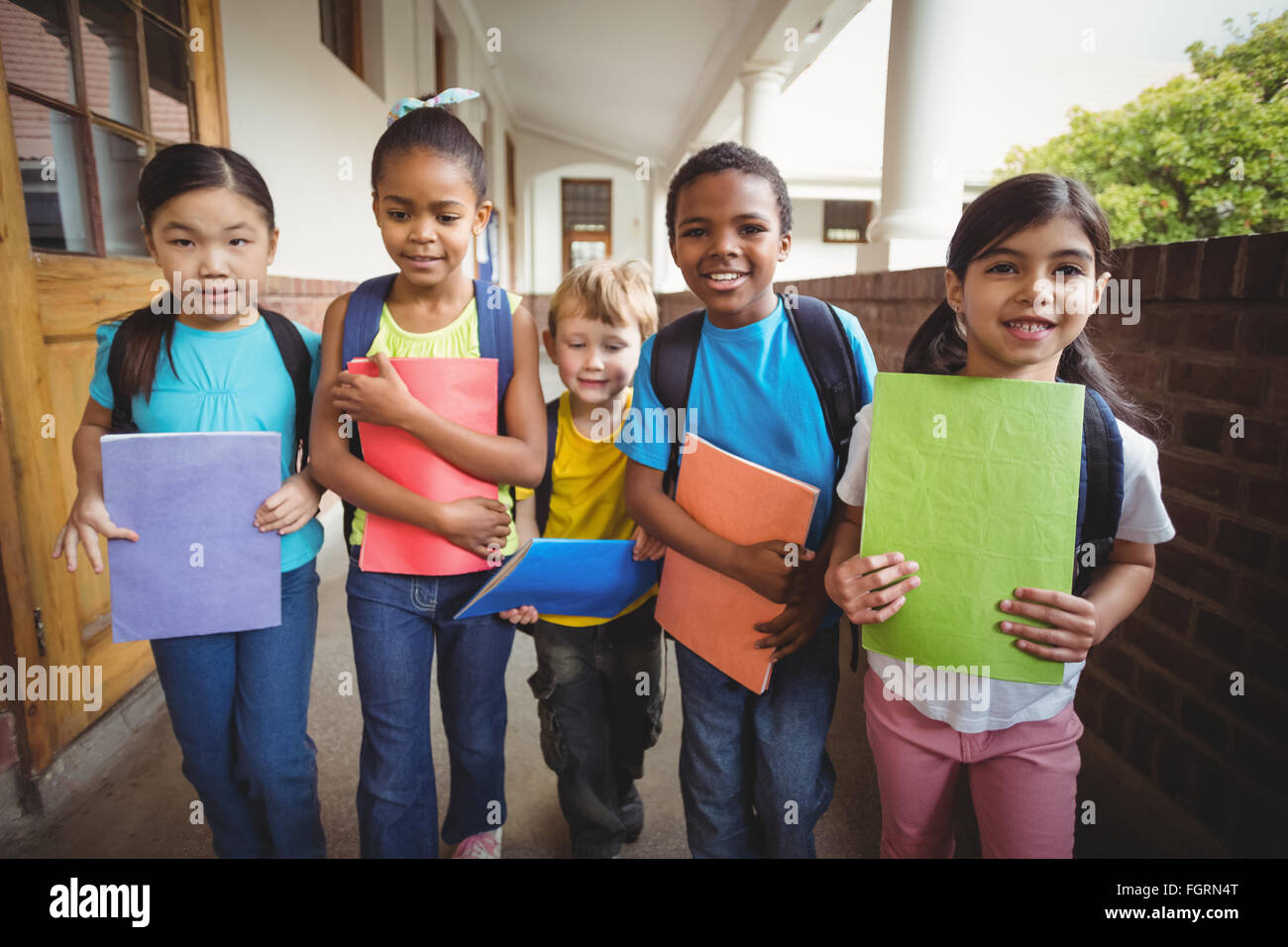 Pupils Notebook Cute pupils holding notebooks at corridor Stock Photo - Alamy