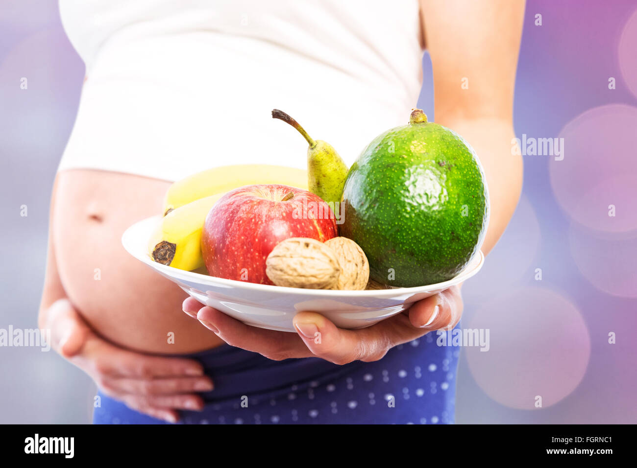 Composite image of pregnant woman showing fruit and veg Stock Photo Alamy