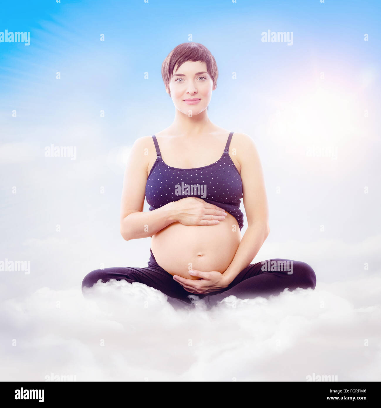 Composite image of portrait of happy expecting woman sitting on exercise mat Stock Photo