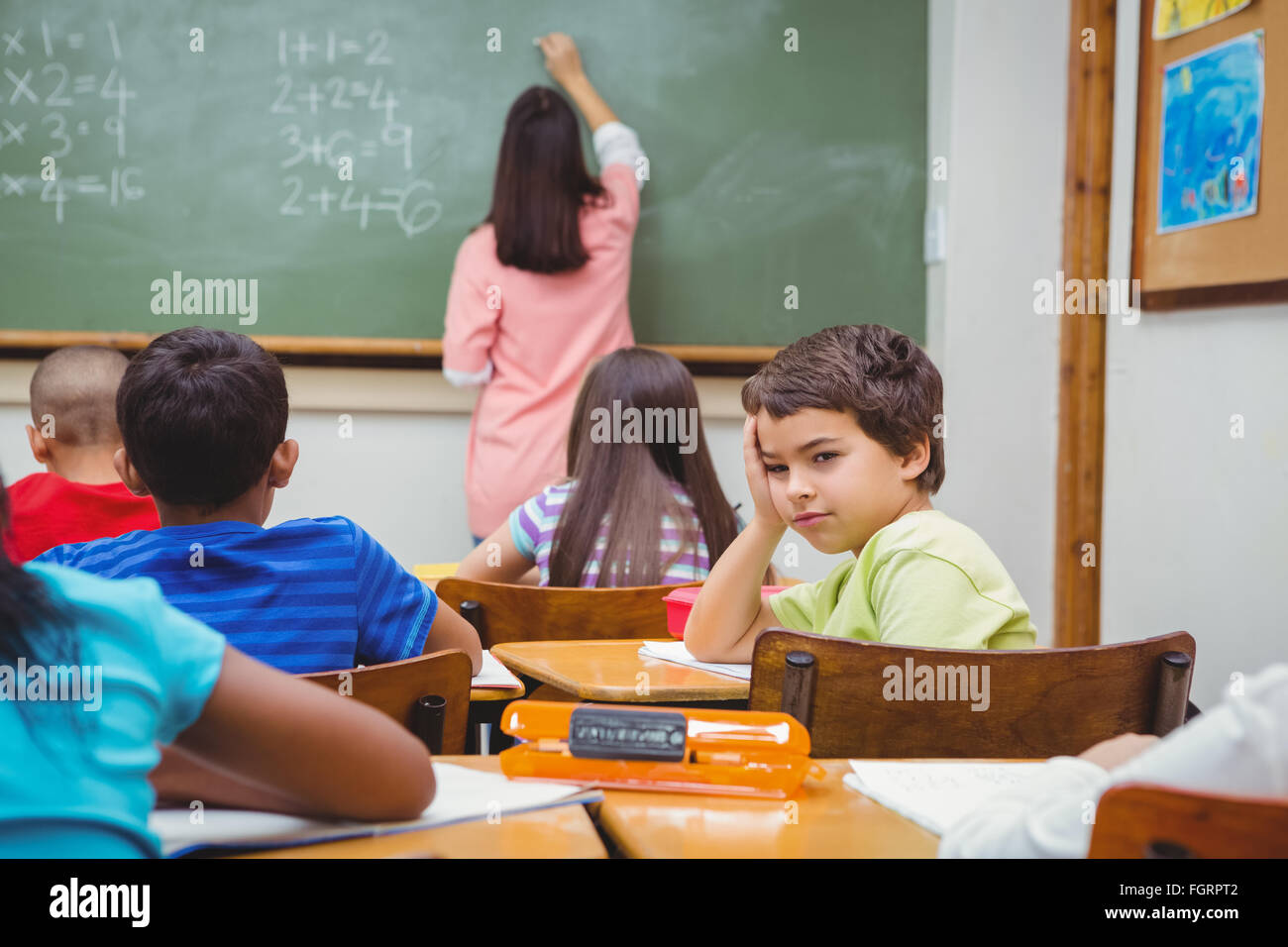 Bored student looking away from board Stock Photo - Alamy