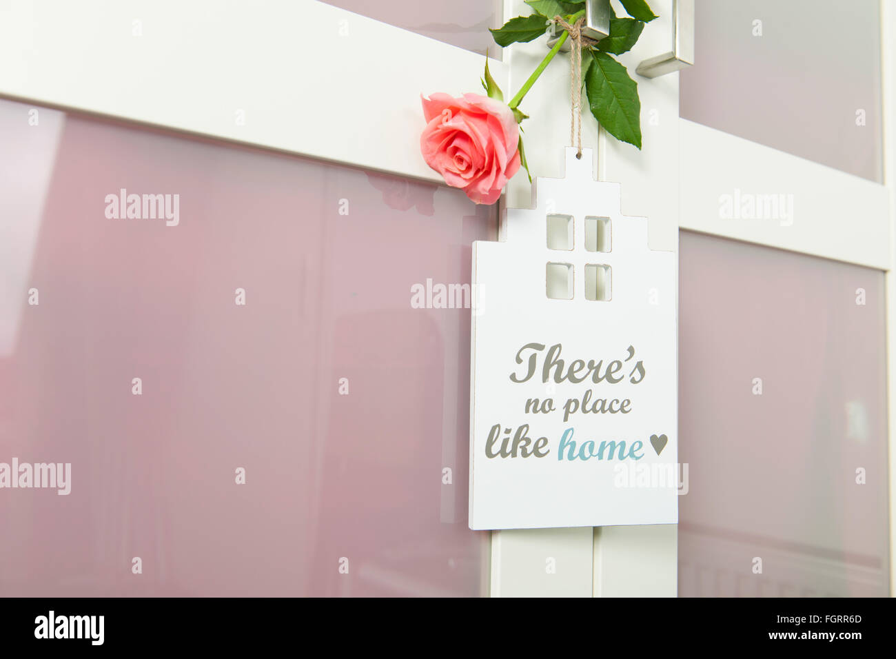 door hanger with no place like home with rose Stock Photo