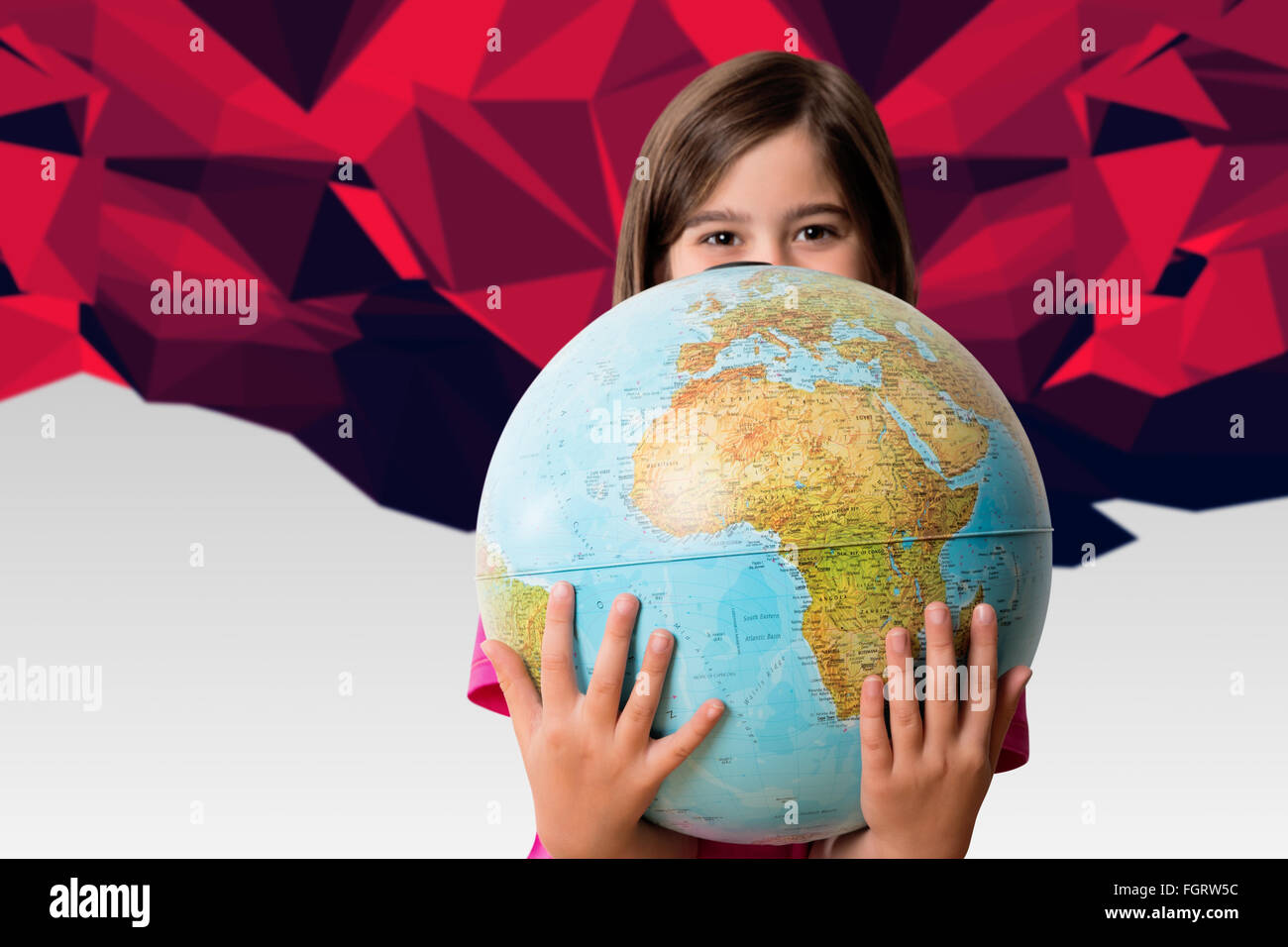 Composite image of cute pupil smiling holding globe Stock Photo - Alamy