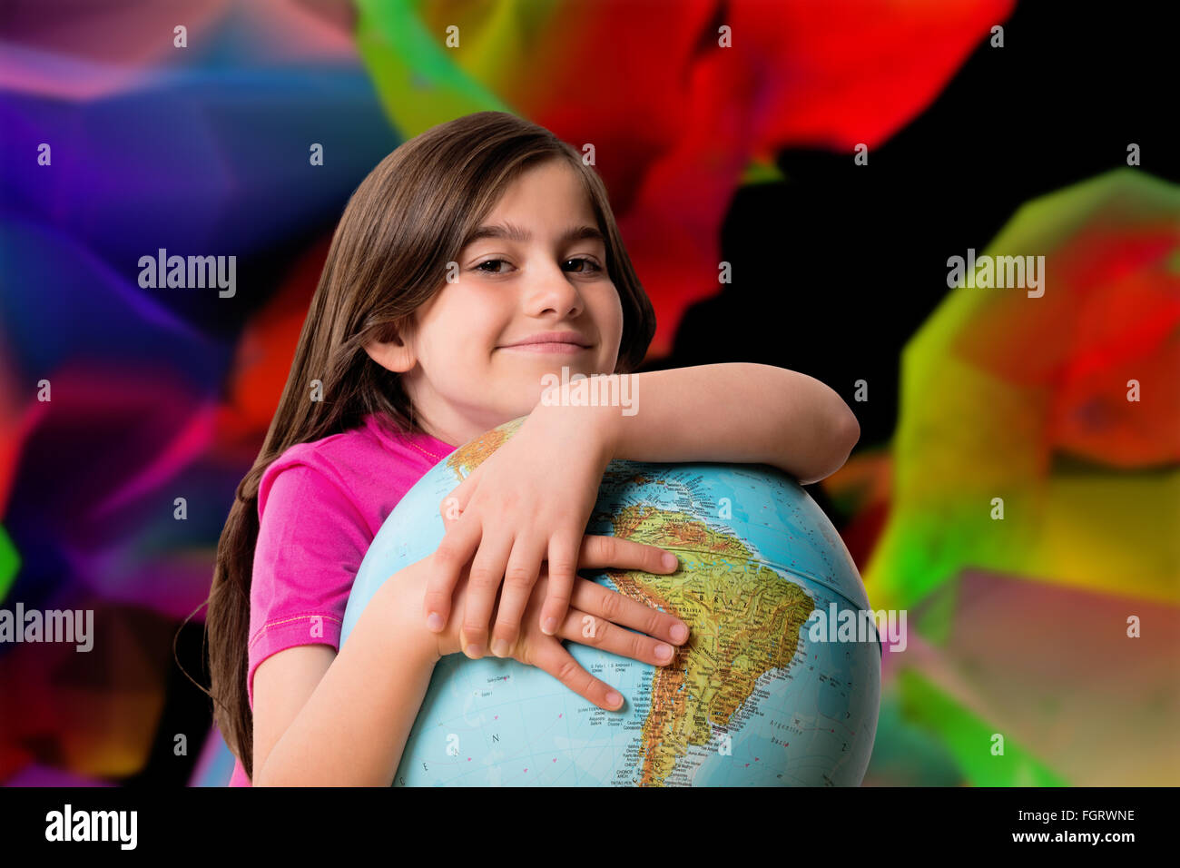 Composite image of cute pupil smiling holding globe Stock Photo - Alamy
