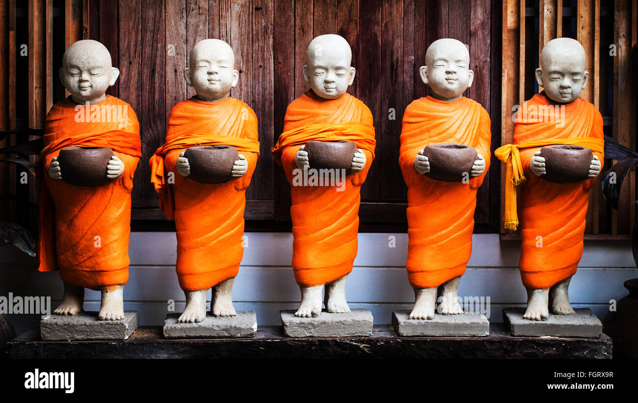 Monk statue holding bowl Stock Photo Alamy