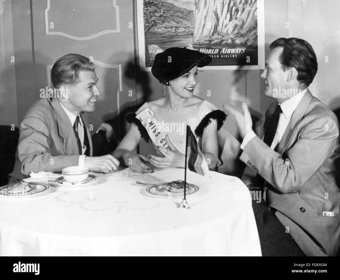 people,women,beauty pageants,Miss Universe 1952,Miss Germany Renate Hoy,half length,with Jochen Grossmann,giving interview,Hotel Plaza,New York,19.6.1952,20th century,1950s,50s,USA,United States of America,beauty contest,beauty contests,beauty queen,beauty queens,beauty,beauties,belle,belles,sitting,sit,clothes,outfit,outfits,hat,hats,sash,sashes,smiles,smiling,smile,birth name: Anita Huy,actress,table,tables,conversation,conversations,talks,talking,talk,journalist,journalists,reporter,reporters,press conference,,Additional-Rights-Clearences-Not Available Stock Photo