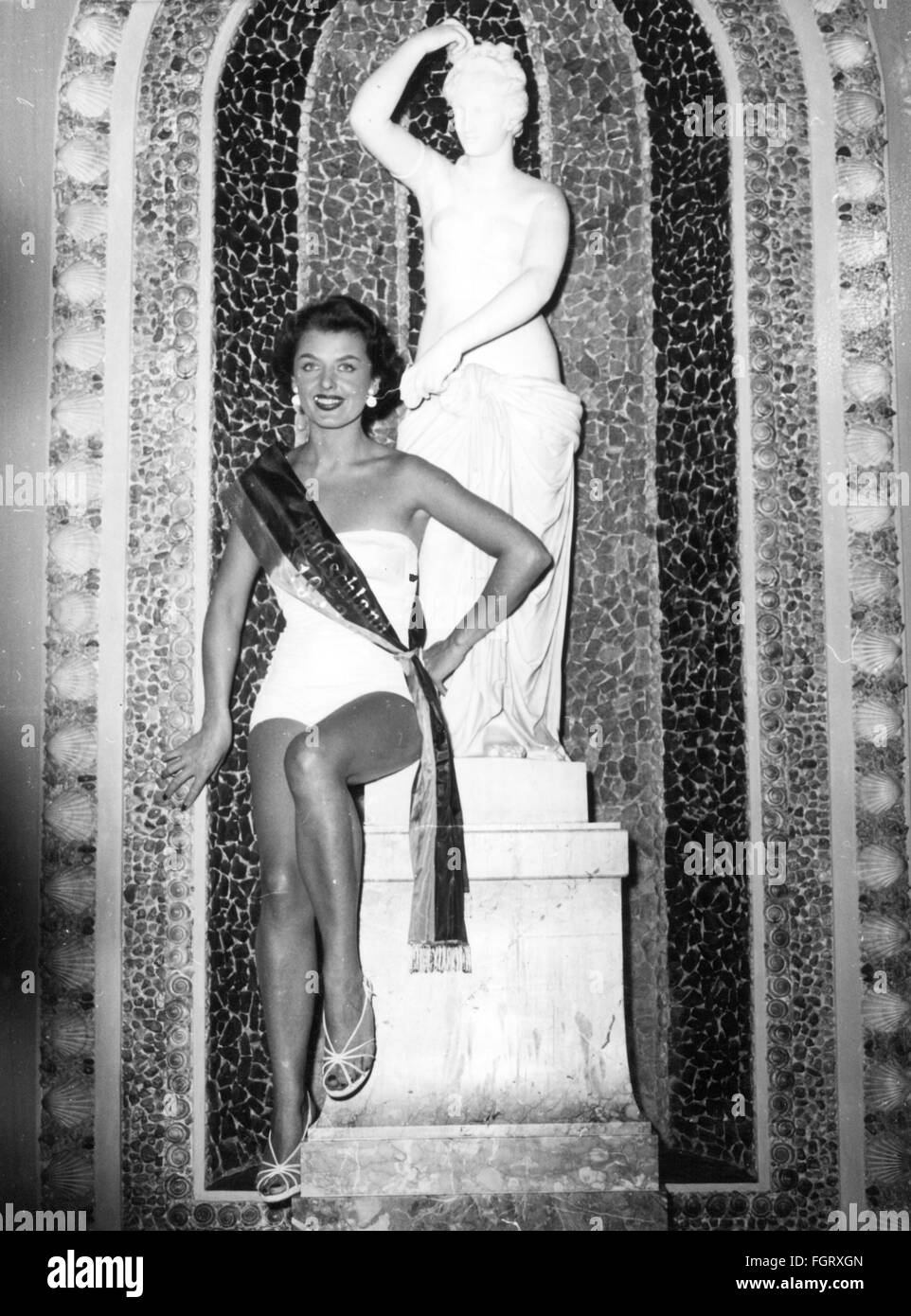 people,women,beauty pageants,Miss Germany 1953,winner Christel Schaack,full length,in front of an Aphrodite statue,kurhaus,Wiesbaden,16.6.1953,20th century,1950s,50s,Germany,beauty contest,beauty contests,beauty queen,beauty queens,beauty,beauties,belle,belles,swimsuit,bathing suit,swimming costume,swimsuits,bathing suits,standing,smiles,smiling,smile,sash,sashes,fine arts,art,sculpturing,statue,statues,sculpture,sculptures,goddesses,goddess of love,love goddess,love,Venus,Miss Berlin,beauty pageants,beauty pageant,Additional-Rights-Clearences-Not Available Stock Photo