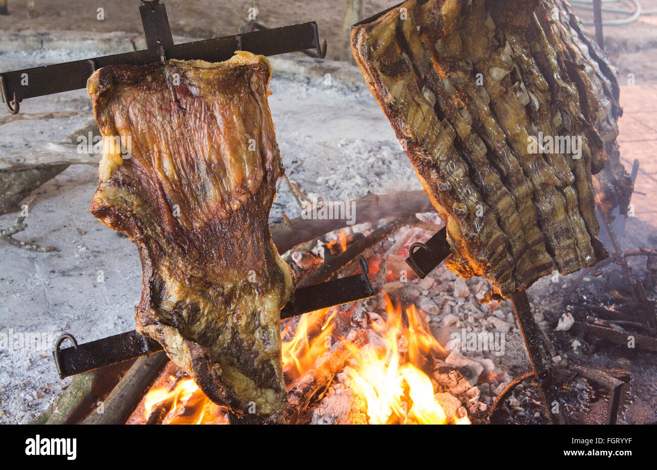 Buenos Aires Argentina cooking food beef ribs on fire Gaucho cowboy ranch for tourists outside city called Don Silvano Ranch Stock Photo