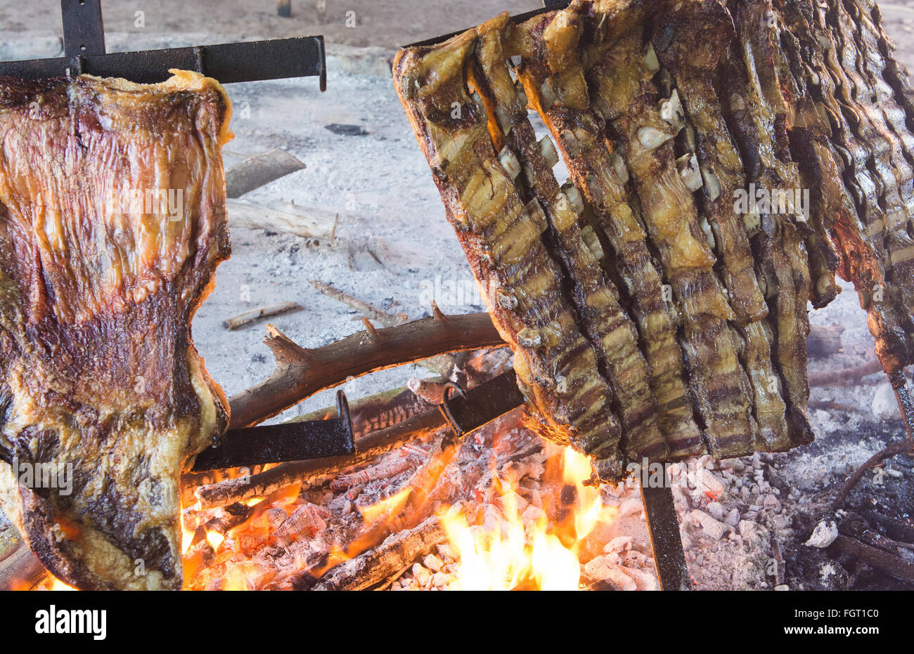 Buenos Aires Argentina cooking food beef ribs on fire Gaucho cowboy ranch for tourists outside city called Don Silvano Ranch Stock Photo