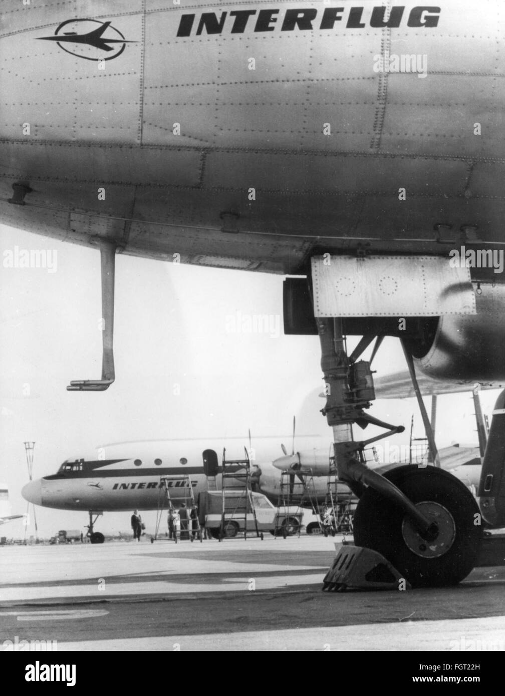 transport / transportation,aviation,airport,Germany,Berlin-Schoenefeld Airport,apron,aircrafts of the airline Interflug,East Berlin,September 1963,aeroplane,airplane,airplanes,aeroplanes,Ilyushin Il-18,Il 18,passenger planes,passenger plane,airliner,brake block,East-Germany,GDR,DDR,East Germany,Eastern Germany,1960s,60s,20th century,people,transport,transportation,airport,airports,apron,airport ramp,aircraft,airline,airline company,airlines,historic,historical,Schoenefeld,Schönefeld,Schonefeld,Berlin-Schoenefeld,Berli,Additional-Rights-Clearences-Not Available Stock Photo