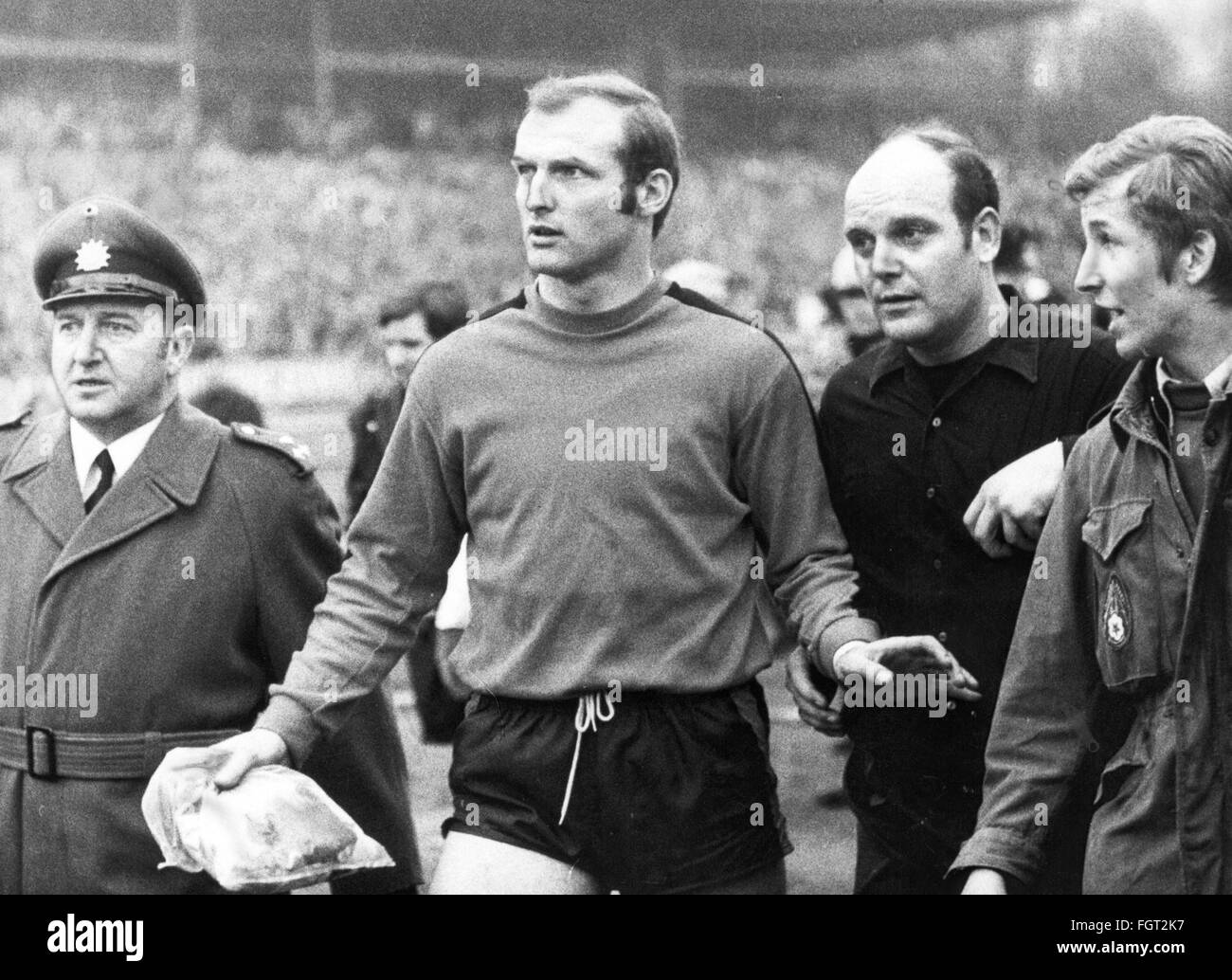 sports,football,matches,Germany,national league,1969 / 1970,28th match day,game 1. FC Koeln against Rot-Weiss Oberhausen,riot,goal keeper Manfred Manglitz and police have to protect the linesman Klaus Ohmsen,Muengersdorf stadium,Cologne,21.3.1970,rumpus,affray,turmoil,athletes,athlete,footballer,footballers,kicker,referee,ref,referees,red white,West Germany,Western Germany,Germany,1970s,70s,20th century,people,men,man,male,football,soccer,footballs,soccer balls,national league,German professional football league,German p,Additional-Rights-Clearences-Not Available Stock Photo