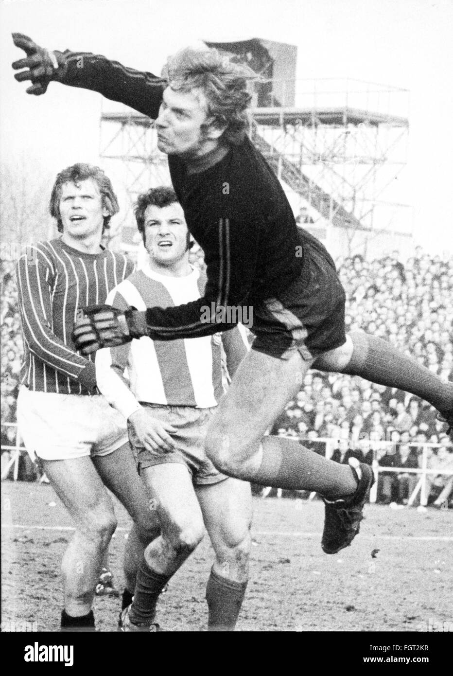 sports,football,games,Germany,DFB-Pokal,1970 / 1971,second round,game Fortuna Duesseldorf versus Wuppertaler SV(4:0),Flinger Broich,Duesseldorf,20.2.1971,save of the Wuppertal goal keeper Willi Janzik,behind Reiner Geye and Emil Meisen,DFB cup,football match,soccer match,football matches,footballer,footballers,kicker,football player,football players,action,act,actions,acts,jumping,jumps,jump,West Germany,Western Germany,Germany,1970s,70s,20th century,people,men,man,male,football,soccer,footballs,soccer balls,second ro,Additional-Rights-Clearences-Not Available Stock Photo