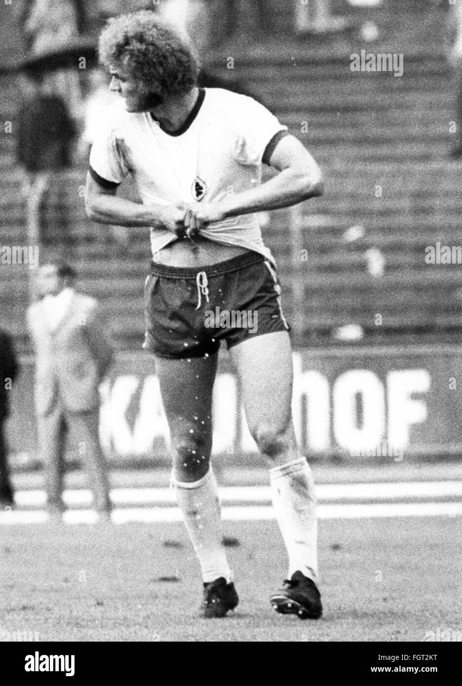 sports,football,games,Germany,national league,season 1970 / 1971,32rd match day,game 1. FC Koeln versus Rot-Weiss Oberhausen(2:4),Muengersdorf stadium,Cologne,22.5.1971,Wolfgang Kliemann(Oberhausen)wrings his sweat soak jersey out,football match,soccer match,football matches,footballer,footballers,kicker,football player,football players,wring out,wringing out,wrung out,perspiration,exertion,exertions,strain,straining,sweaty,heat,hot,West Germany,Western Germany,Germany,1970s,70s,20th century,people,full length,man,men,,Additional-Rights-Clearences-Not Available Stock Photo