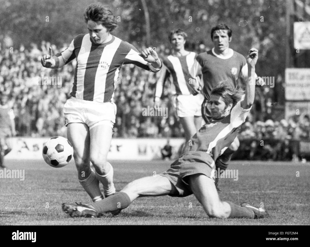 sports,football,games,Germany,national league,season 1970 / 1971,29th match day,game Rot-Weiss Essen versus Hertha BSC(0:3),Georg-Melches-Stadion,Essen,1.5.1971,defender Peter Czernotzky(Essen)stops striker Arno Steffenhagen(Berlin),Rot Weiss,football match,soccer match,football matches,footballer,footballers,kicker,football player,football players,action,act,actions,acts,assaults,assault,attack,offensive move,attacks,offensive moves,defences,defenses,defense,defence,leg lay,sliding tackle,running,run,runs,ball,playi,Additional-Rights-Clearences-Not Available Stock Photo