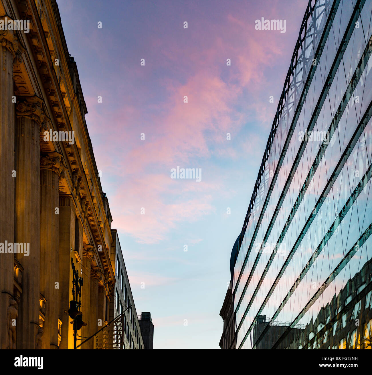 Sunset reflection in glass panels of modern building in Pest part of Budapest city, Hungary, Europe. Old and classical building Stock Photo