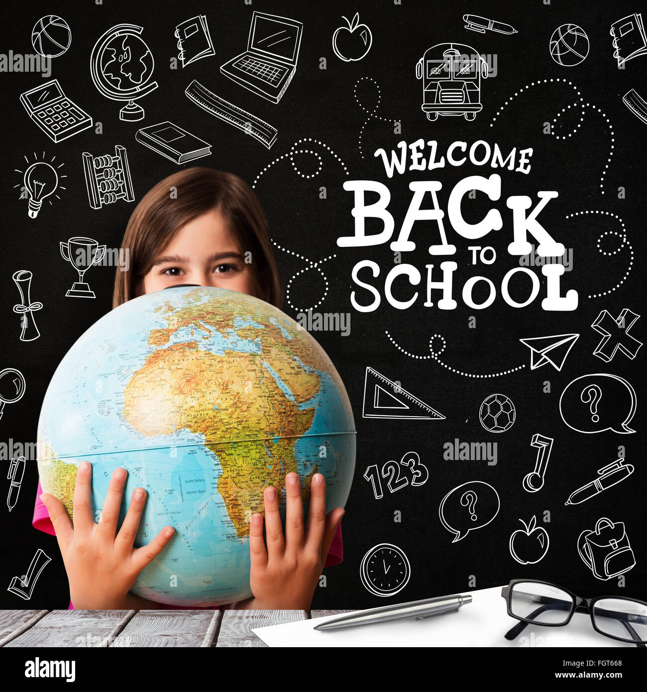 Composite image of cute pupil smiling holding globe Stock Photo - Alamy