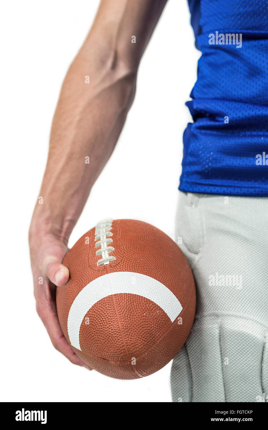 Midsection of sports player holding ball Stock Photo