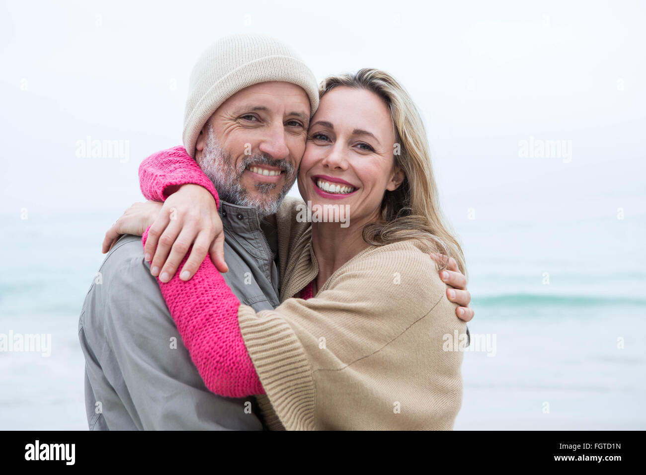 Cute couple standing and holding each other Stock Photo - Alamy