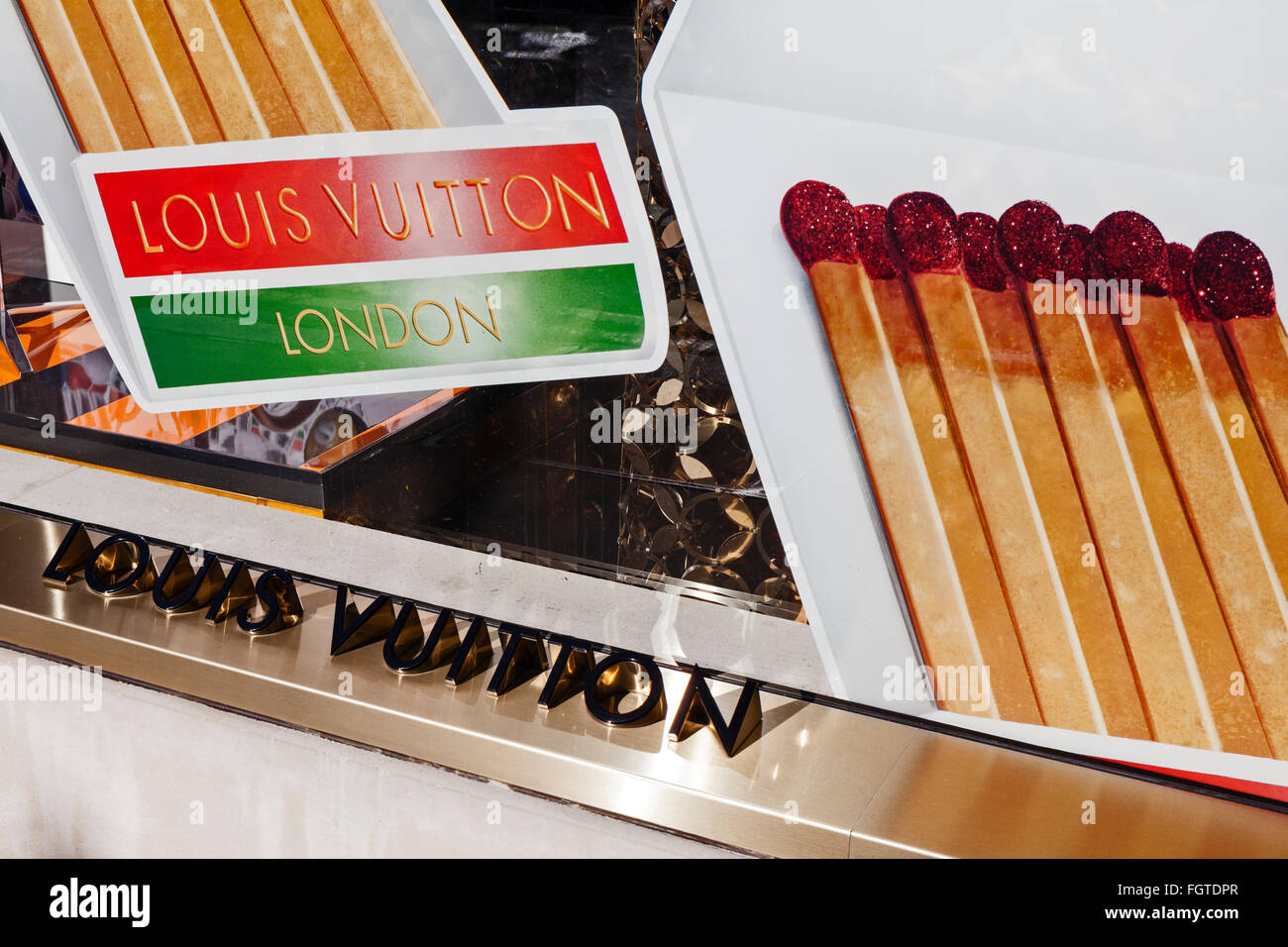 Louis Vuitton brand signage in a window in Mayfair, London. Stock Photo